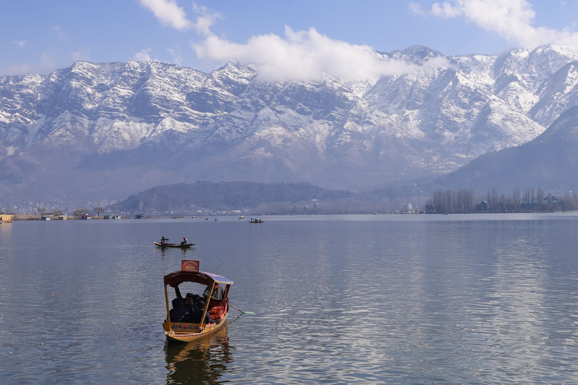 Shikara on Dal Lake with Srinagar mountains
